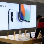 A customer looks at an Apple Inc. iPhone X at a SoftBank Group Corp. store in Tokyo, Japan, on Thursday, Feb. 22, 2018. Billionaire founder Masayoshi Son said this month that the company will start preparing for the mobile IPO and aims for a listing within a year. It could still end up scrapping the plan, the company said on Feb. 7. Photographer: Akio Kon/Bloomberg via Getty Images