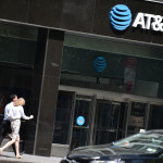 People walk by an AT&T store in New York City, on May 11, 2018. (Photo by HECTOR RETAMAL / AFP)        (Photo credit should read HECTOR RETAMAL/AFP/Getty Images)