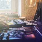 close up man making music in the home studio using drum machines