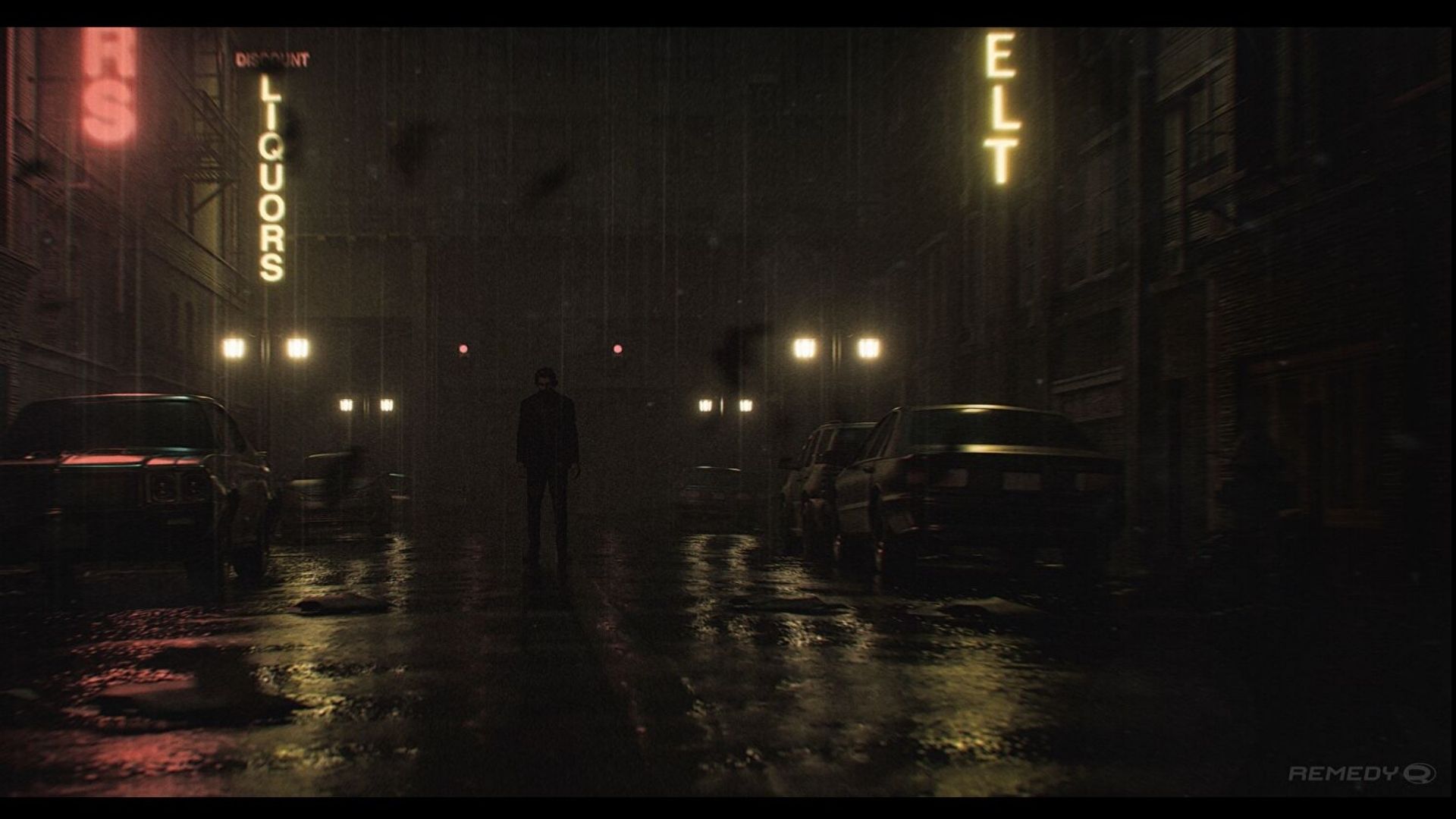 A moody cityscape. Water pools on the floor as neon signs bounce light around the dark streets. Alan Wake stands at the centre of the image.